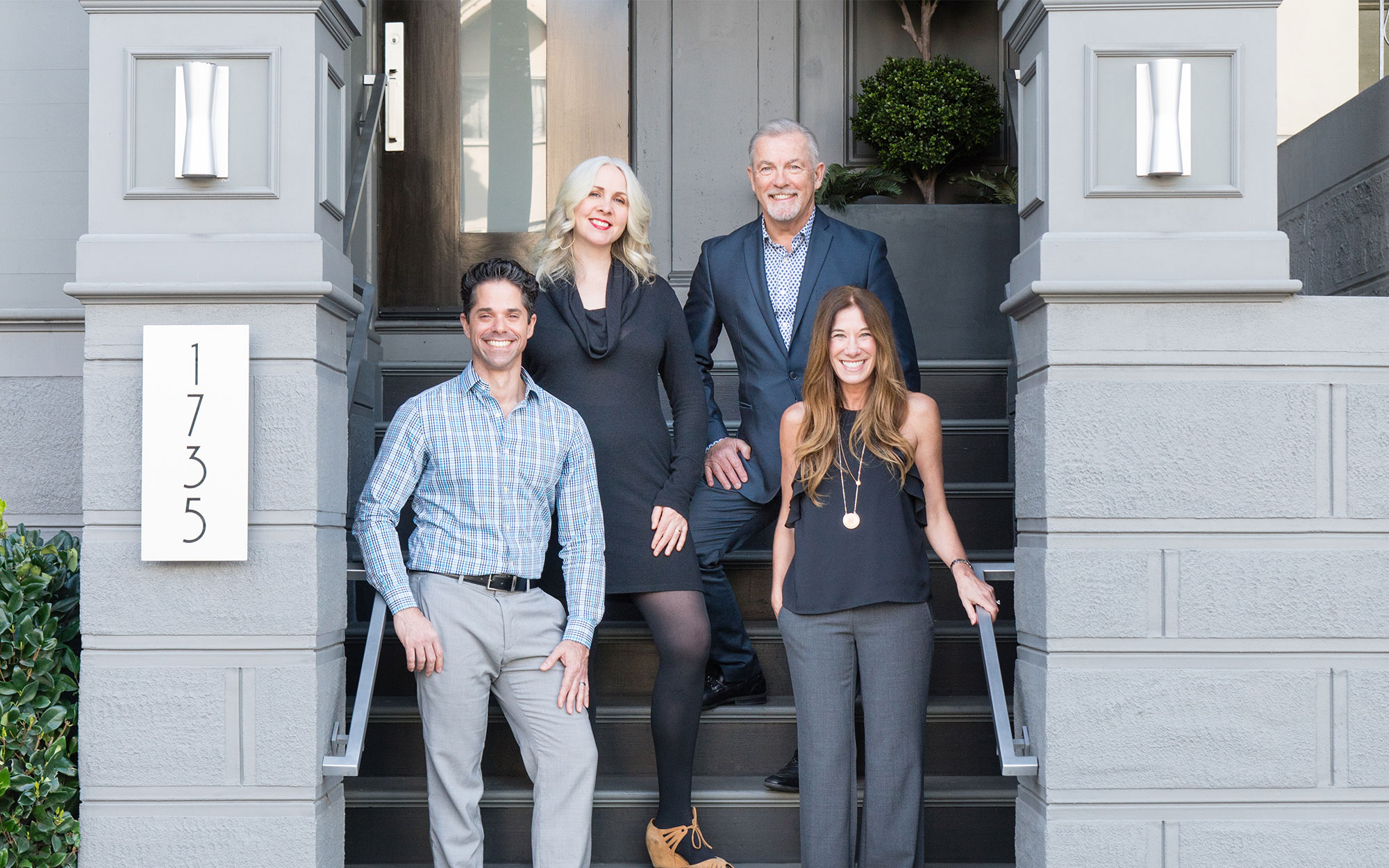 The Real SF Properties team members standing in front of a house