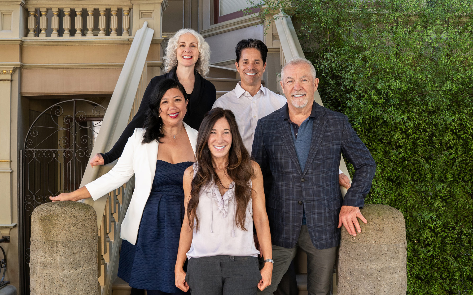 The Real SF Properties team members standing in front of a house